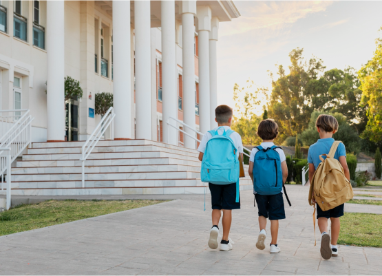 Three children with backpacks walking along a path, symbolizing a sustainable future for the next generation.