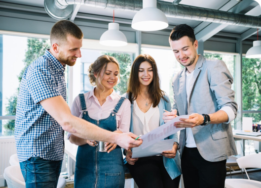 Business colleagues engaged in teamwork within a contemporary office setting.