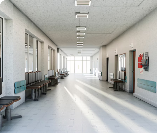 A long hallway featuring benches along the sides and large windows allowing natural light to enter.