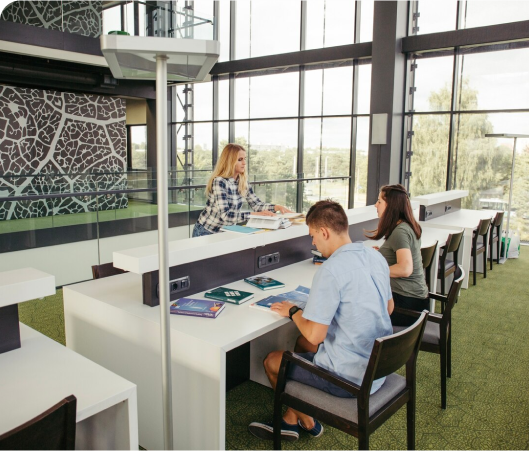 A group of students engages in collaborative work at a library table, reflecting a modern and adaptable study space.