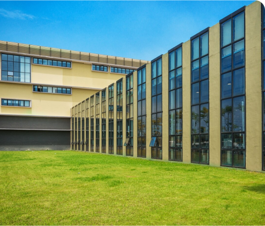 A contemporary structure with expansive windows, set against a backdrop of vibrant grass, representing financial prosperity.