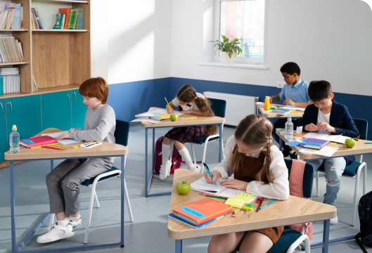 A classroom scene featuring children attentively seated at their desks, engaged in learning activities.