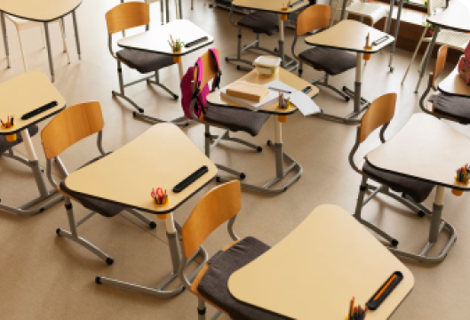 A classroom filled with neatly arranged desks and chairs, showcasing a conducive learning environment.