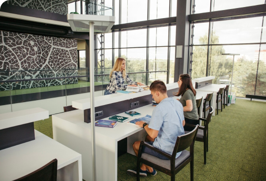 A diverse group of students studying together in a library, highlighting the importance of collaboration and knowledge sharing.