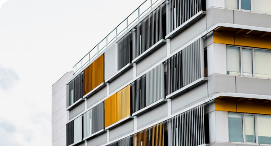 A modular building featuring striking yellow and black windows, showcasing a modern architectural design.