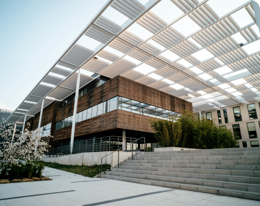 A modern building featuring a pergola on its roof, showcasing efficient resource use in architectural design.