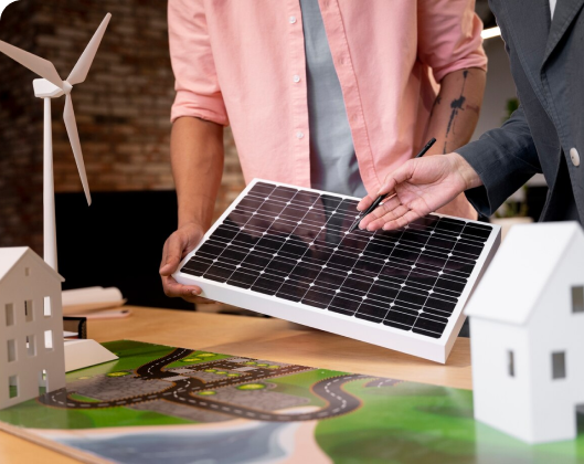 Two individuals hold a solar panel and a house model, symbolizing energy efficiency and sustainable living practices.