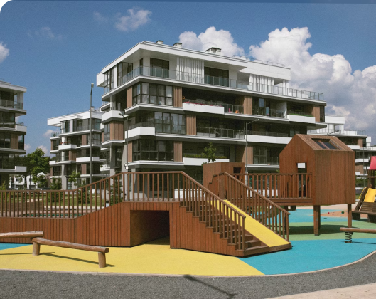 A playground featuring a wooden slide alongside a vibrant yellow and blue play structure, promoting outdoor activity and play.