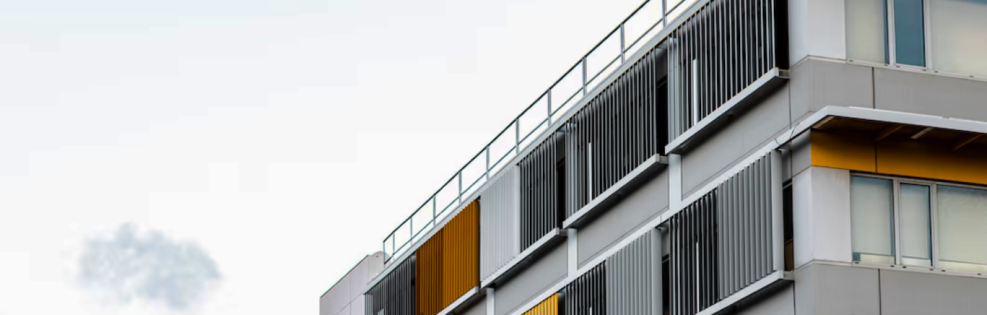 A building featuring a modern design with yellow and gray panels adorning its exterior walls.